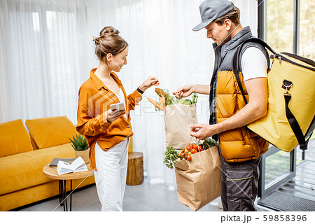 Courier delivering groceries home 59858396