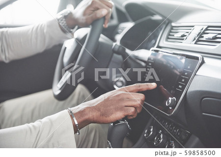 Stylish black businessman sitting behind the wheel of new luxury car. Rich african american man 59858500