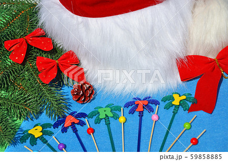 Santa Claus hat on a branch of spruce and toys. Santa Claus hat on a branch of spruce and toys. 59858885