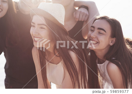 Happy friends have fun on the beach - Young people playing in open air water on summer holidays Happy friends have fun on the beach - Young people playing in open air water on summer holidays 59859377