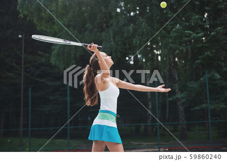 Portrait of a beautiful woman practicing tennis. Portrait of a beautiful woman practicing tennis. 59860240