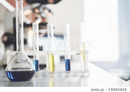 Flask with blue purple pink liquid laboratory cork stand on the table in the test laboratory fluid 59860868
