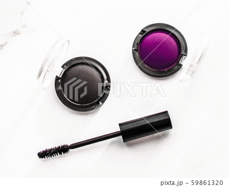 Eyeshadows, black liner and mascara on marble 59861320