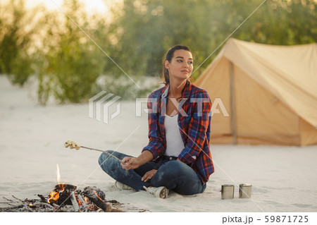 Woman Camping Near Campfire Woman Camping Near Campfire 59871725