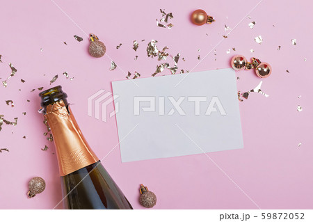 Blank paper card mock-up on the pink background with golden confetti and champagne bottle Blank paper card mock-up on the pink background with golden confetti and champagne bottle 59872052