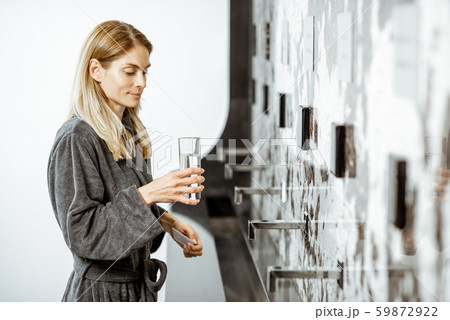 Woman drinking mineral water at the pump-room Woman drinking mineral water at the pump-room 59872922