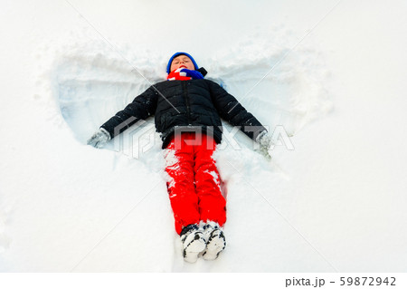 A handsome boy in the winter depicts an angel on A handsome boy in the winter depicts an angel on 59872942