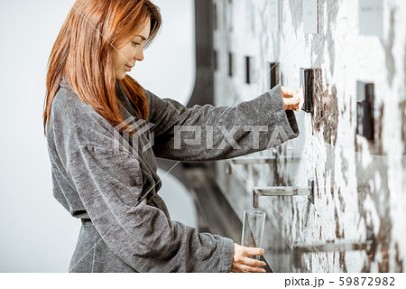 Woman drinking mineral thermal water 59872982