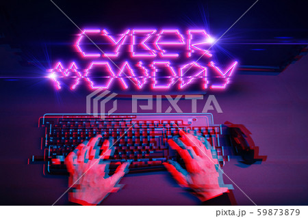 Male player sitting next to laptop on black background, pink inscription. 59873879