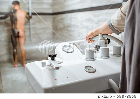 Man having high pressure shower in the spa salon 59873959