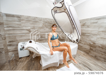 Woman on the spa capsule in the beauty salon Woman on the spa capsule in the beauty salon 59874076