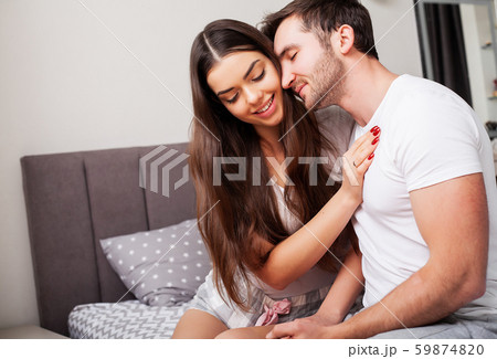 Loving couple relaxing in bed at home 59874820