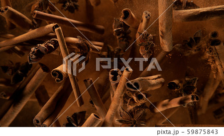 Cinnamon barks with star anise lfying in the air Cinnamon barks with star anise lfying in the air 59875843