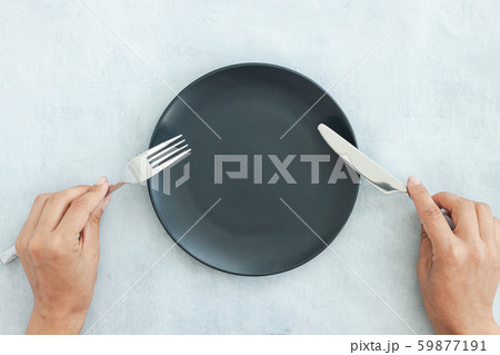 Empty black plate on dark stone background. Empty black plate on dark stone background. 59877191