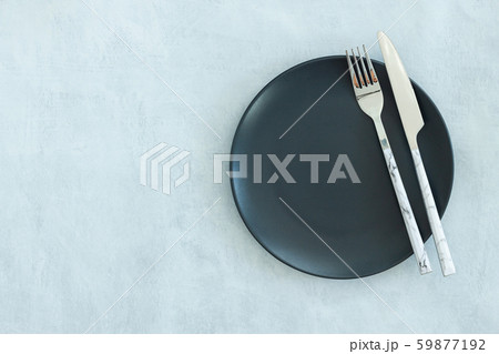 Empty black plate on dark stone background. Empty black plate on dark stone background. 59877192