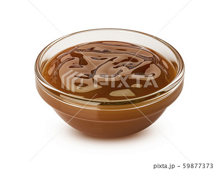 Caramel sauce in small glass bowl isolated on white background Caramel sauce in small glass bowl isolated on white background 59877373