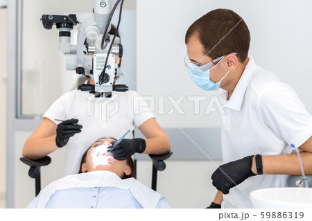 High class service in dental cabinet, two dentists making surgery 59886319