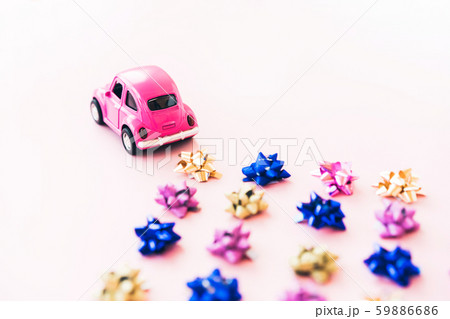 Small toy kids car and multi colored bows for gift wrapping Small toy kids car and multi colored bows for gift wrapping 59886686
