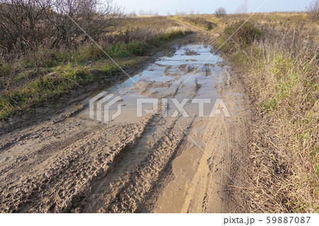 Impassable dirt road. Puddle and dirt on the road Impassable dirt road. Puddle and dirt on the road 59887087