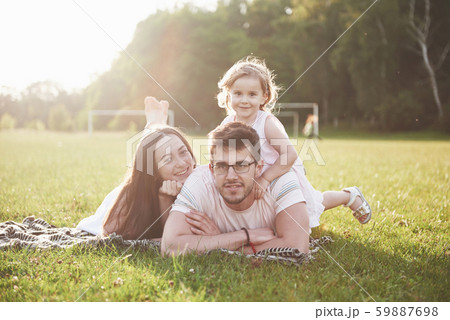 Happy family, father of mother and daughter of baby in the nature at sunset Happy family, father of mother and daughter of baby in the nature at sunset 59887698