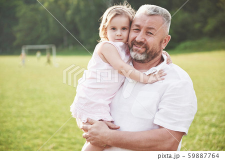 Portrait of grandfather with granddaughter, relaxing together in the park 59887764