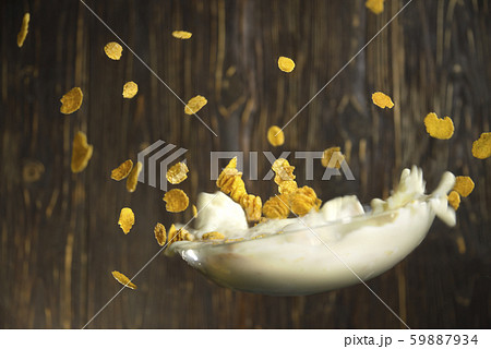 plate with cereal with milk flies on a background 59887934