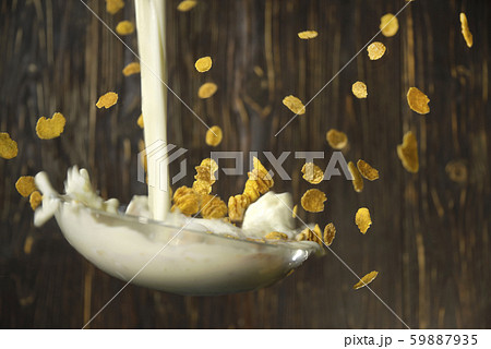 plate with cereal with milk flies on a background 59887935