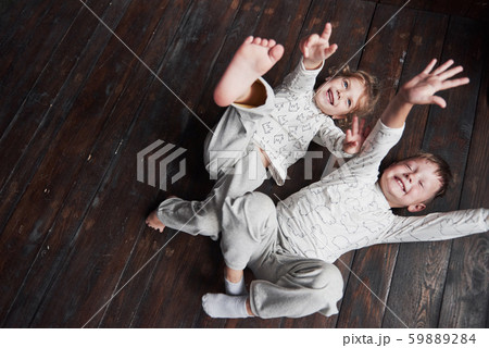Two children, brother and sister in pajamas play together 59889284