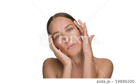 Close-up beauty portrait of young woman with smooth healthy skin, she gently touches her face with 59890200