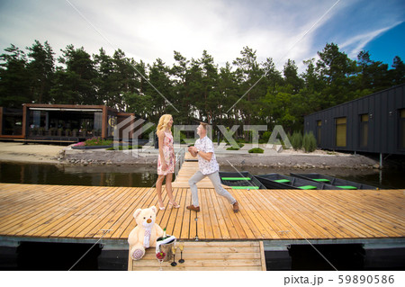 Young cute guy makes a marriage proposal to his 59890586