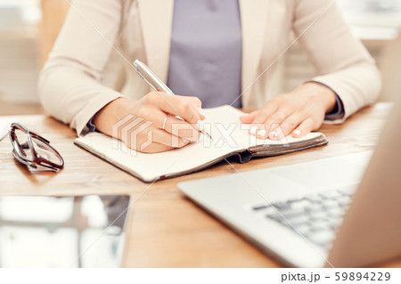Closeup Businesswoman Writing at Workplace 59894229