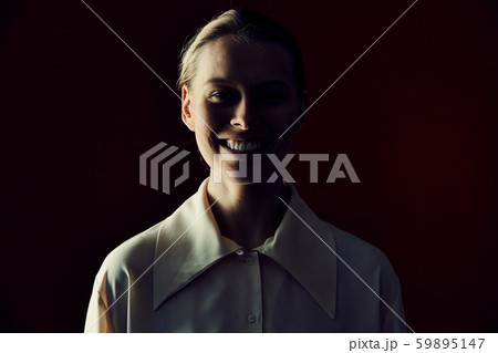 Smiling Young Woman in Dark 59895147