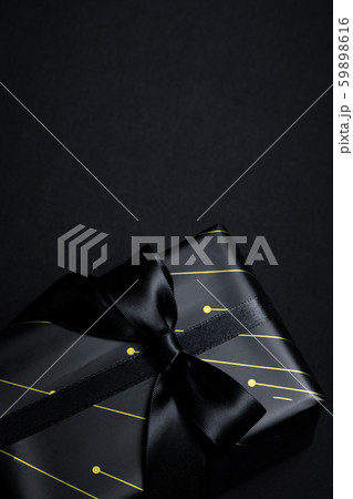 Top view of black gift box with black ribbons Top view of black gift box with black ribbons 59898616