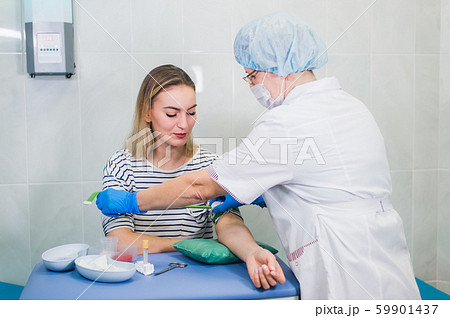 Nurse takes blood from a vein for a blood test 59901437