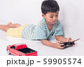 cute little boy play semi-automatic toy car on 59905574