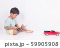 cute little boy play semi-automatic toy car on 59905908
