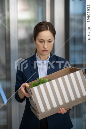 Dark-haired woman feeling stressed and depressed after dismissal 59905931