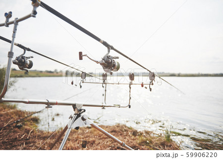 Carp fishing rods standing on special tripods. Expensive coils and a radio system of crochet 59906220