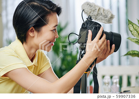 Woman setting camera properties Woman setting camera properties 59907336