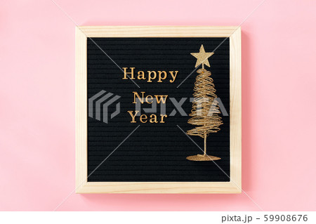 Letter board with golden text Happy New year and shiny christmas tree on pink background. New year 59908676