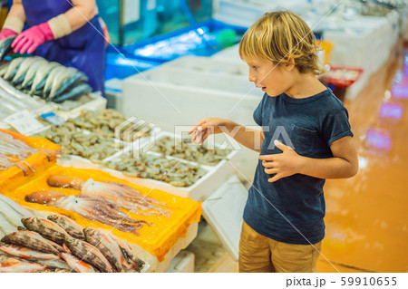 Boy in the Korean market. Raw seafood at Noryangjin Fisheries Wholesale Market in Seoul, South Korea 59910655