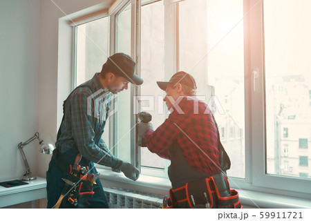 Provading best service. Men are installing a window Provading best service. Men are installing a window 59911721