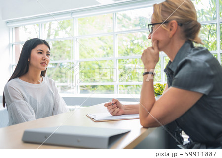 woman talking and listening to senior female woman talking and listening to senior female 59911887