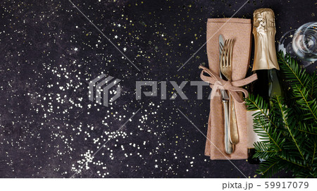 Champagne bottle with christmas decoration on dark background 59917079