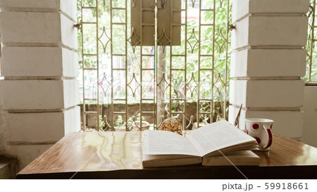 Coffee and book by window on a sunday morning. 59918661