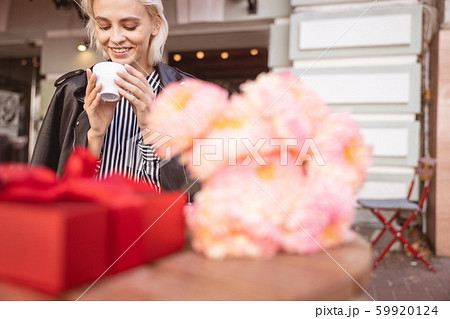 Cheerful girl waiting for her friend on her birthday Cheerful girl waiting for her friend on her birthday 59920124