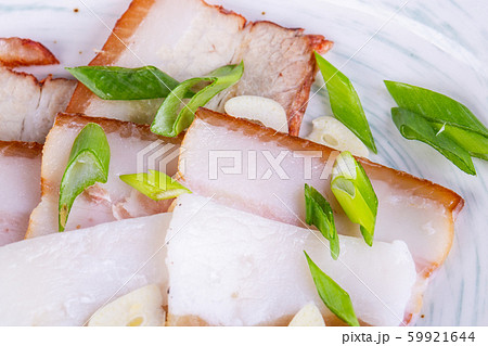 Pieces of layered lard with cut green onions and garlic Pieces of layered lard with cut green onions and garlic 59921644