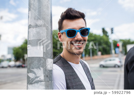 Front view of young blind man standing in city. Front view of young blind man standing in city. 59922796