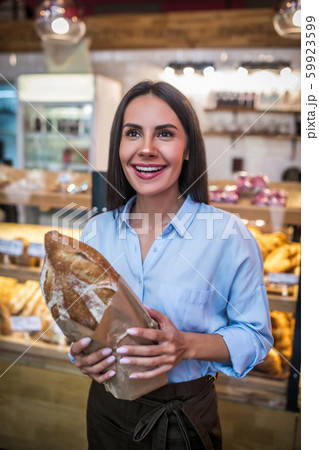 Appealing young businesswoman feeling excited early in the morning Appealing young businesswoman feeling excited early in the morning 59923599