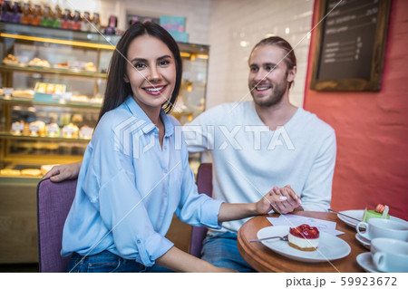 Couple enjoying their weekend morning in cafeteria Couple enjoying their weekend morning in cafeteria 59923672